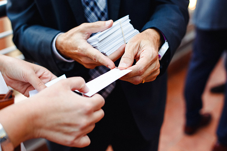 Businessman giving a blank business card to client
